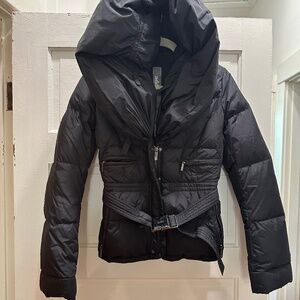 Black down belted jacket with dramatic shawl collar/hood.